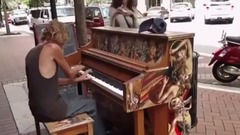 The Tramp is playing with an old piano
